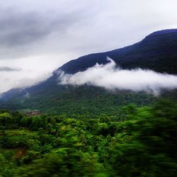 Scenic view of mountains against cloudy sky