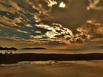 Scenic view of beach against sky during sunset