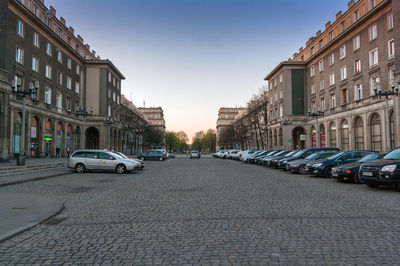 Cars on street amidst buildings in city