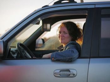 Portrait of happy boy sitting in car