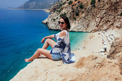 Portrait of young woman standing at beach