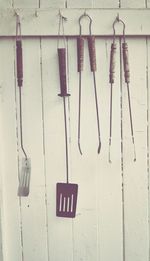 Close-up of barbeque tools hanged on hook