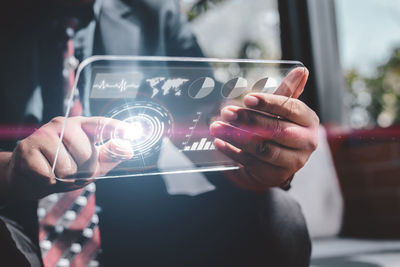 Midsection of man using mobile phone