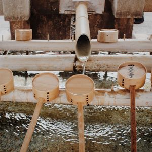 Sacred wooden water ladles in a row inside a shrine