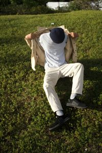 Man pose on top of grassfield