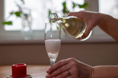 Hand holding glass of wine