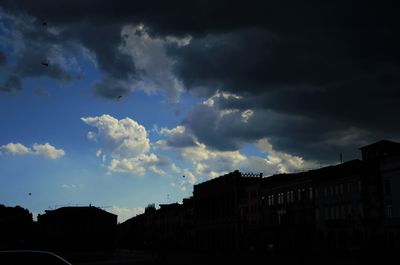 Low angle view of buildings against sky at sunset