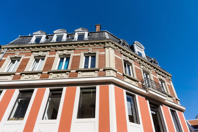 Low angle view of building against blue sky