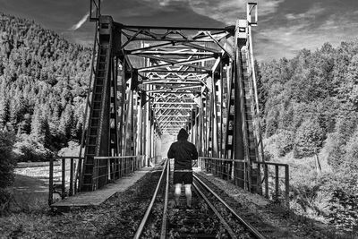 Rear view of person on railroad tracks