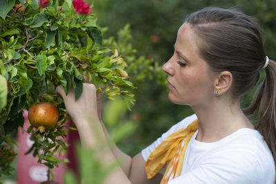 Portrait of young woman holding food outdoors