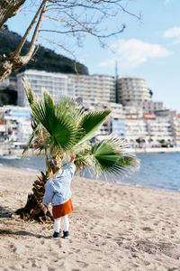 Rear view of woman walking on beach