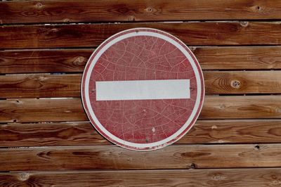 Close-up of old stop sign on wooden wall