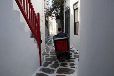 Rear view of man against building in winter