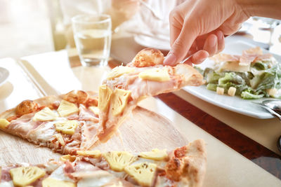 Close-up of pizza served on table in restaurant