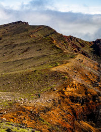 A beautiful view on mountains, sky, clouds and person figure hiking, near active volcano aso