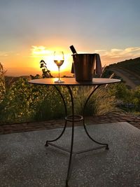 Street light on table against sky during sunset