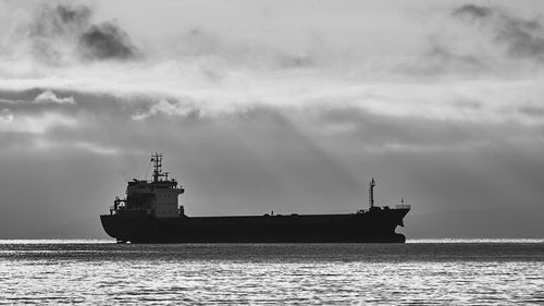 Ship sailing on sea against sky