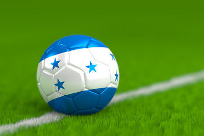 Close-up of soccer ball on grass