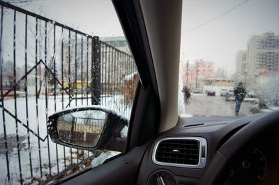 Close-up of cars against sky in city