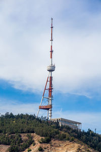 Low angle view of communications tower against sky