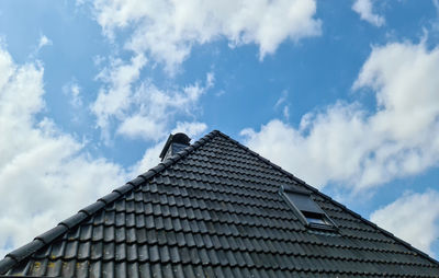 Low angle view of building roof against sky