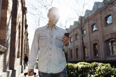 Man using mobile phone in city