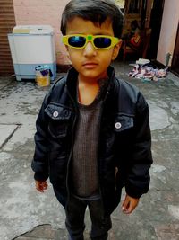 Full length of boy wearing sunglasses standing outdoors