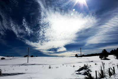 Snow covered land against sky