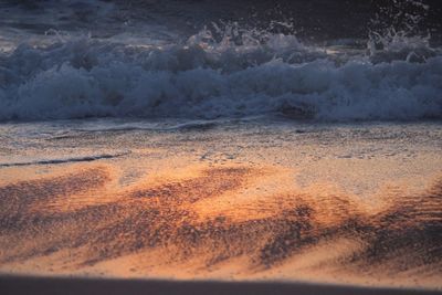 Close-up of waves at sunset