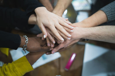 Midsection of people holding hands