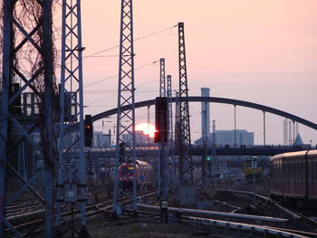 Railroad tracks against sky during sunset