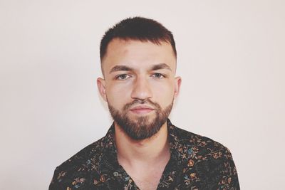 Portrait of young man against white background