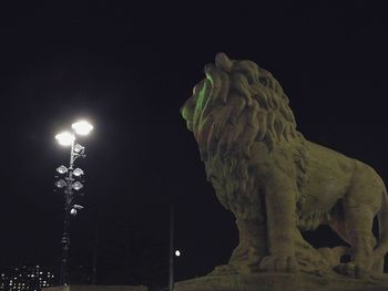 Low angle view of illuminated lights at night