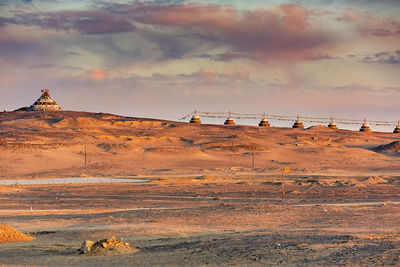 Scenic view of land against sky during sunset