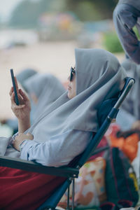 Midsection of woman using mobile phone