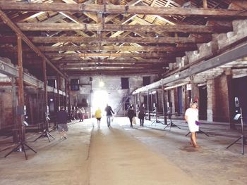 Full length of woman walking on tiled floor