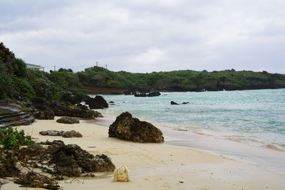 Rocks on beach against sky