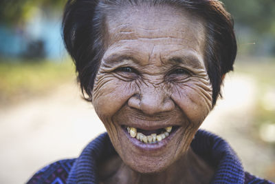 Close-up portrait of smiling woman outdoors