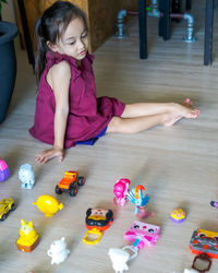 High angle view of girl playing with toy at home