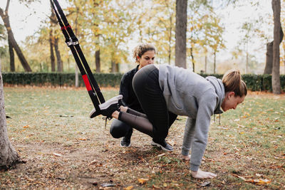 Low angle view of women exercising at park