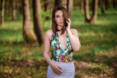 Beautiful young woman standing on field