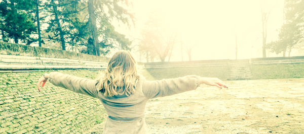 Woman standing by tree in water