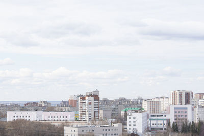 High angle view of buildings in town against sky