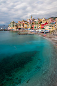 Scenic view of sea and buildings against sky