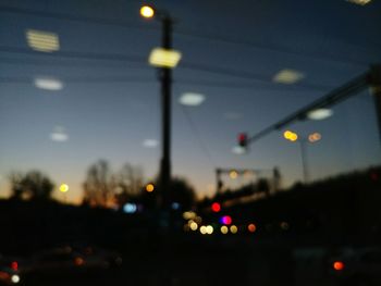 Close-up of illuminated city against sky at night