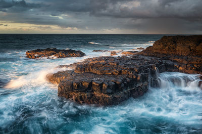 Scenic view of sea against cloudy sky