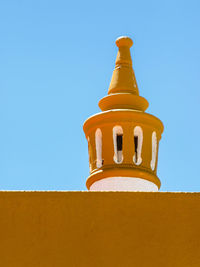 Low angle view of building against clear blue sky