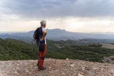 Senior hiker standing on viewpoint