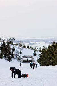 Snowboard besides the frozen lake .rope car journey