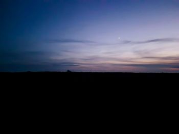 Scenic view of silhouette landscape against sky at sunset